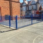 Blue steel commercial railings surrounding a schoolyard in Birmingham.