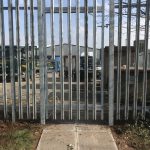 Steel palisade gates in front of an industrial unit. These commercial gates are perfect to keep industrial areas secure.